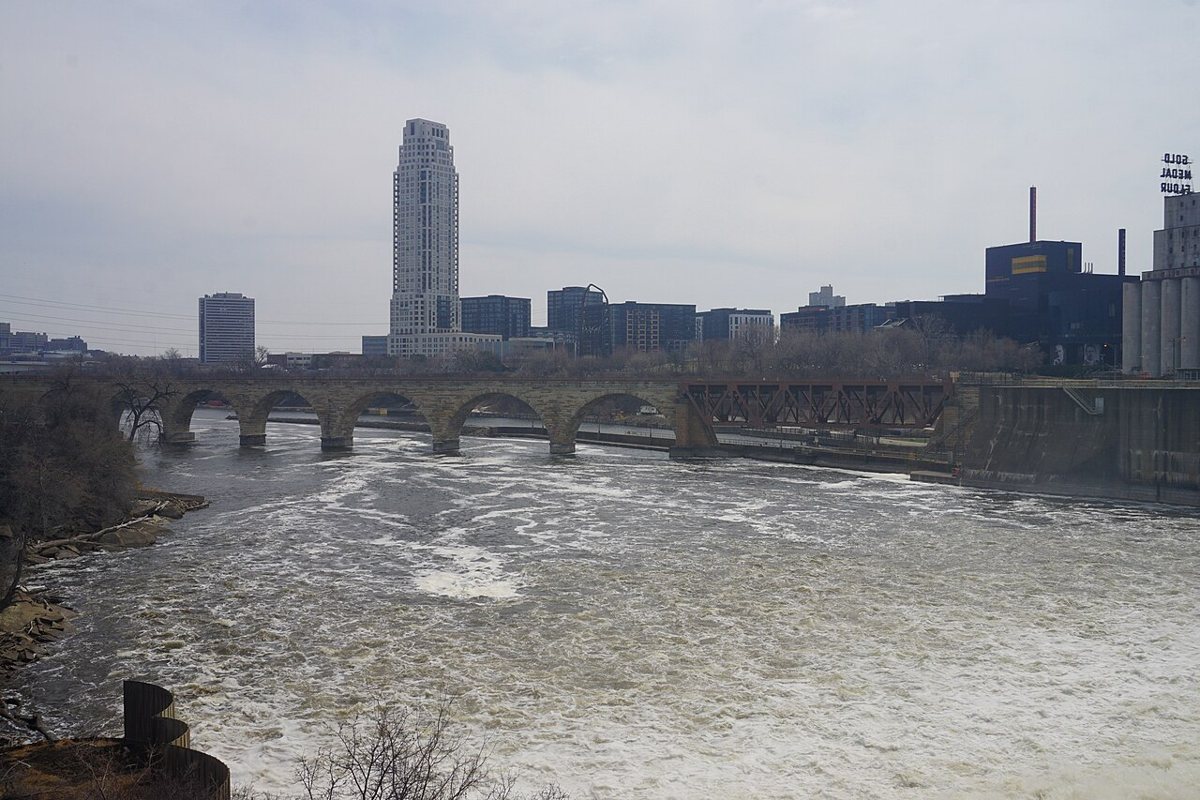 Pedestrians crossing the Stone Arch Bridge over the Mississippi River in Minneapolis