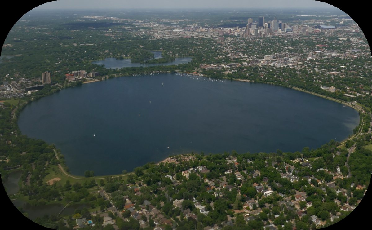Sailboats and paddleboarders on Bde Maka Ska near Uptown Minneapolis