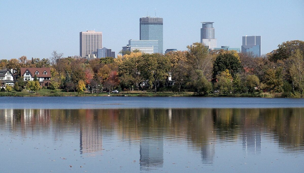 Walking path along Lake of the Isles lined with grand homes in Minneapolis