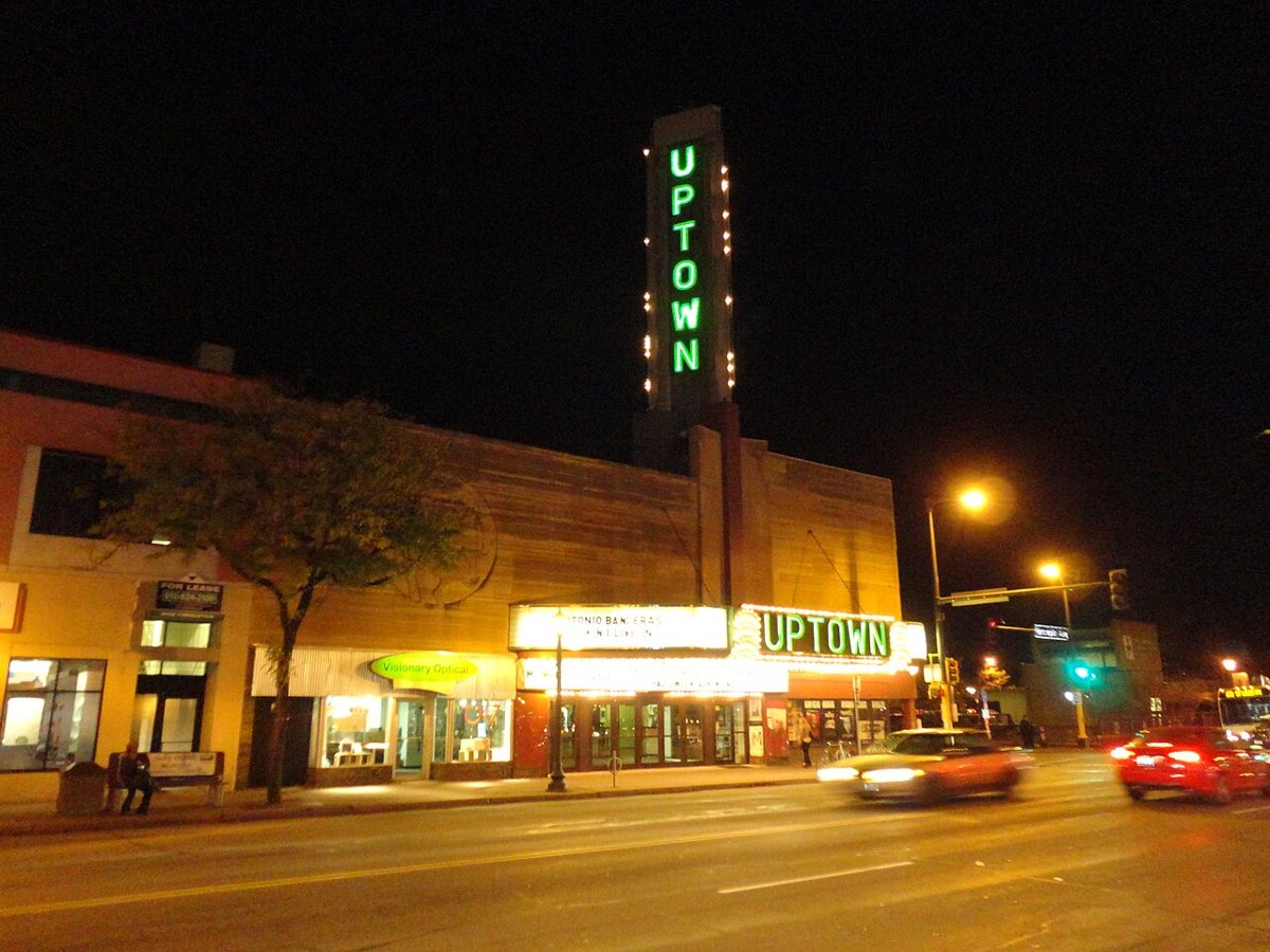 The historic Uptown Theatre marquee glowing at night on Hennepin Avenue
